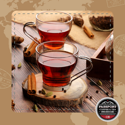 Vanilla Almond Black Tea in glass cups with cinnamon sticks and spices on a wooden table.