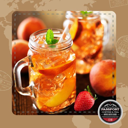 Strawberry Peach Black Tea in mason jar with fresh fruits and mint garnish.