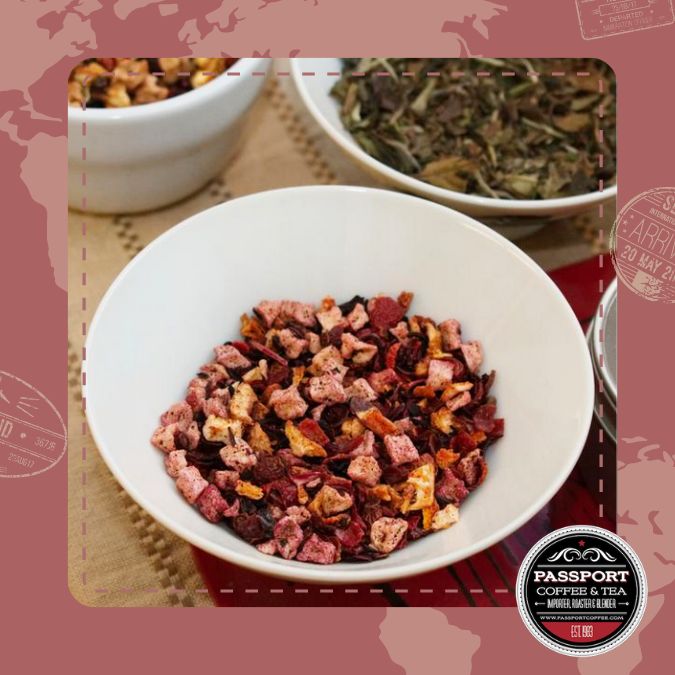 Strawberry Peach Fruit Tea blend with hibiscus petals and dried berries in a white bowl.