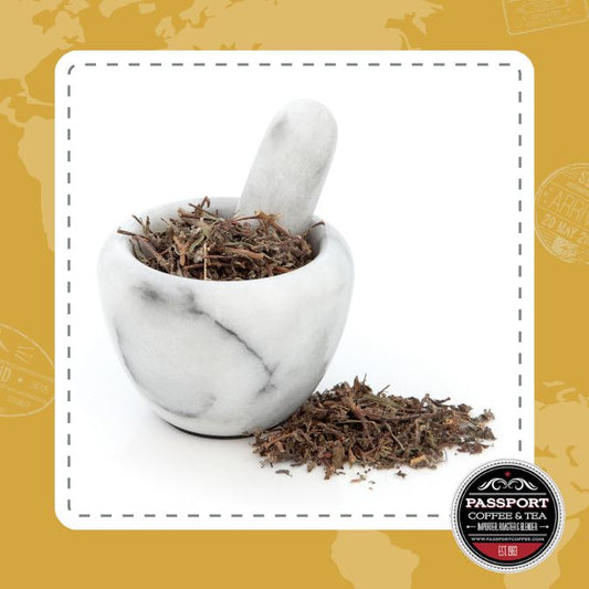 Loose leaf Tulsi Holy Basil Tea in a white marble mortar with a pestle.