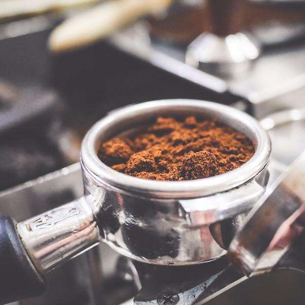 Medium and dark roast European Espresso blend in portafilter, full-bodied and bold flavor.